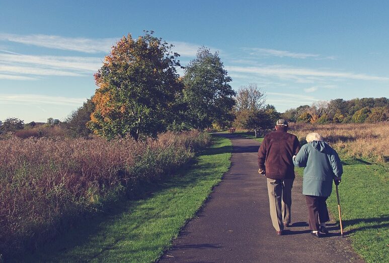 elderly-couple-walking-on-a-park-path-1 Elderly couple walking on a park path in Surrey